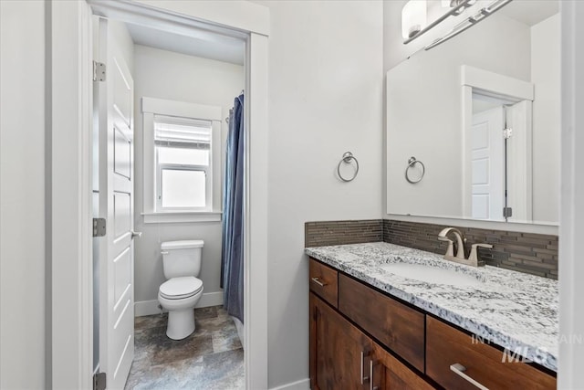 15343 Moss Creek Way, Caldwell, ID 83607 - bathroom featuring backsplash, vanity, toilet, and baseboards