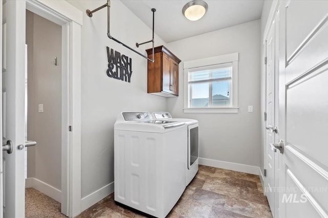 15343 Moss Creek Way, Caldwell, ID 83607 - laundry room featuring washing machine and dryer, cabinet space, baseboards, and stone finish flooring