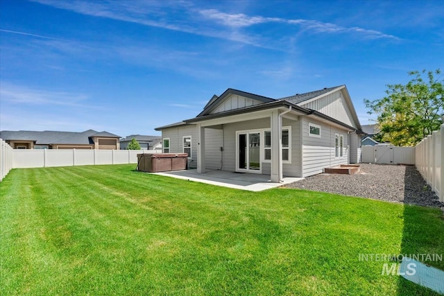 15343 Moss Creek Way, Caldwell, ID 83607 - rear view of house with a hot tub, a patio, board and batten siding, and a gate