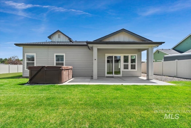 15343 Moss Creek Way, Caldwell, ID 83607 - rear view of house featuring a hot tub, a patio, and board and batten siding