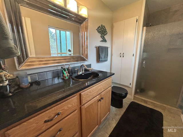 full bathroom featuring toilet, vanity, and a stall shower