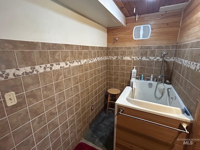 bathroom featuring a tub and tile walls