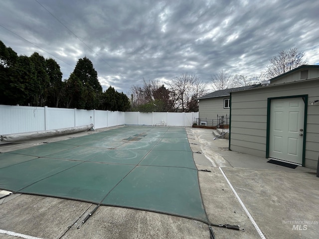 view of swimming pool featuring a fenced in pool, a patio, and a fenced backyard