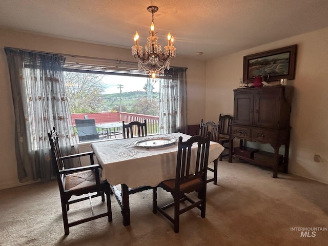 dining area featuring light carpet and an inviting chandelier
