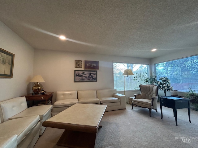 carpeted living room featuring recessed lighting and a textured ceiling