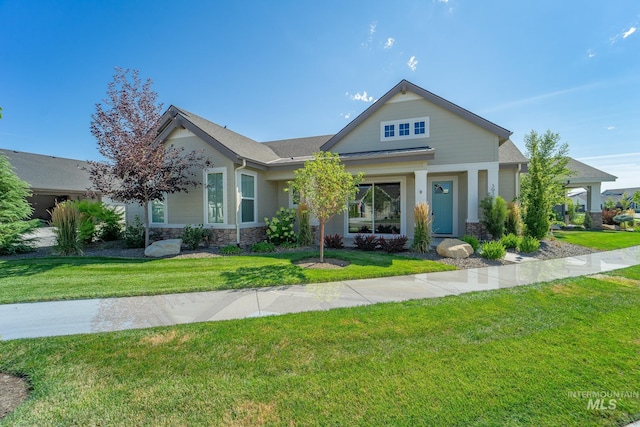 craftsman inspired home featuring stone siding and a front yard