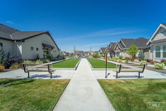 view of property's community featuring a residential view and a lawn