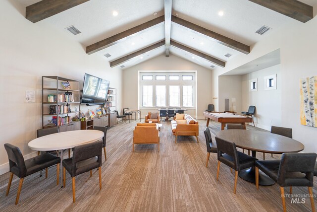 dining space featuring visible vents, beam ceiling, and high vaulted ceiling