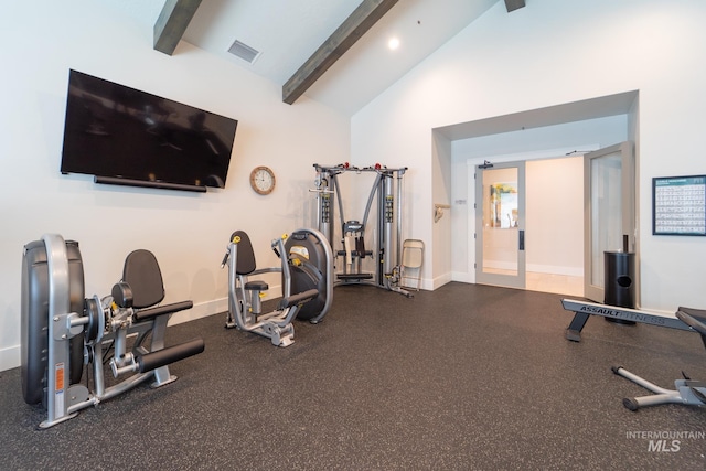 gym featuring visible vents, high vaulted ceiling, and baseboards