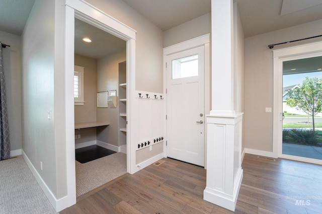 entrance foyer with plenty of natural light, baseboards, and wood finished floors