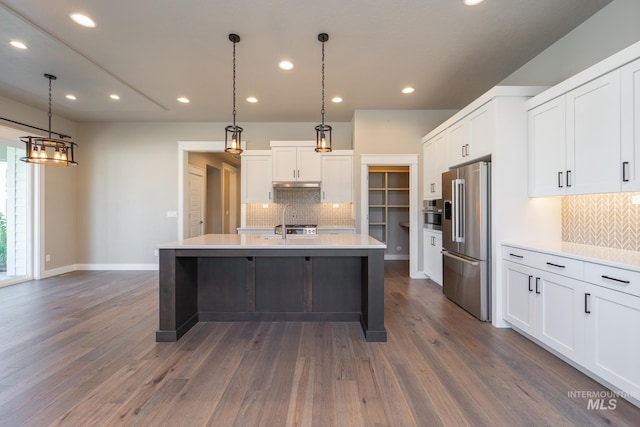 kitchen featuring light countertops, white cabinets, dark wood-style floors, and high end refrigerator