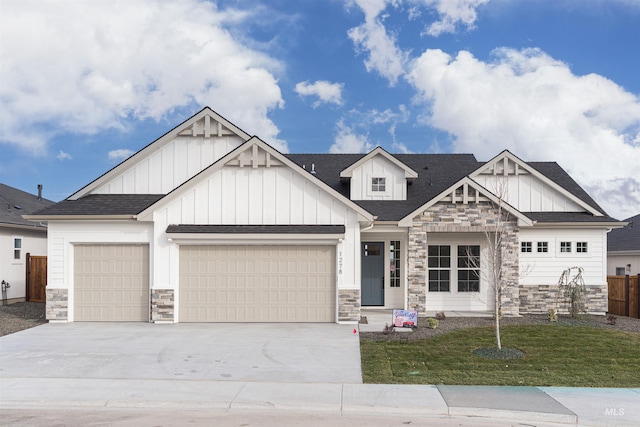 craftsman-style house featuring a garage and a front yard