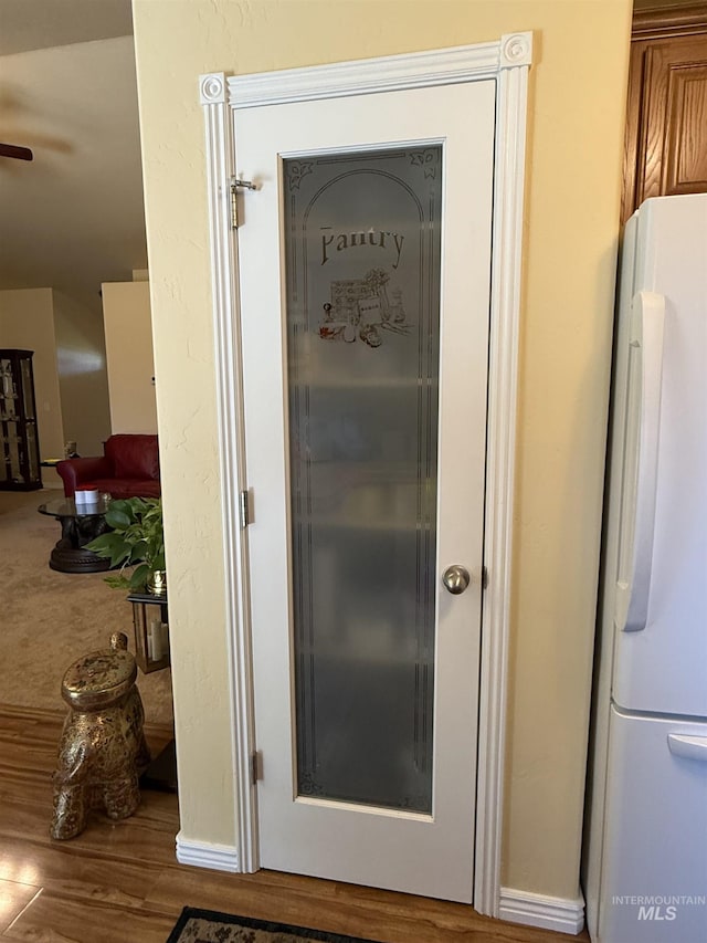 1053 Caswell Ave W, Twin Falls, ID 83301 - detailed view of freestanding refrigerator, ceiling fan, and wood finished floors