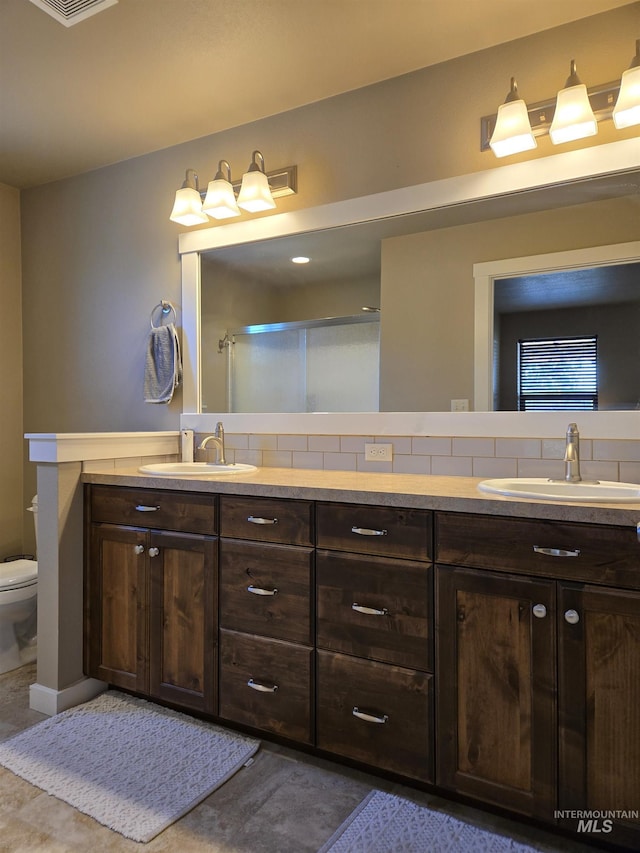 235 Meadow View Dr, Payette, ID 83661 - full bathroom featuring double vanity, decorative backsplash, and an enclosed shower