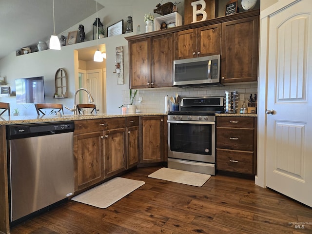 235 Meadow View Dr, Payette, ID 83661 - kitchen with stainless steel appliances, dark wood finished floors, backsplash, light stone counters, and decorative light fixtures