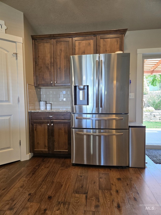 235 Meadow View Dr, Payette, ID 83661 - kitchen with stainless steel fridge with ice dispenser, dark wood-type flooring, backsplash, and light stone countertops