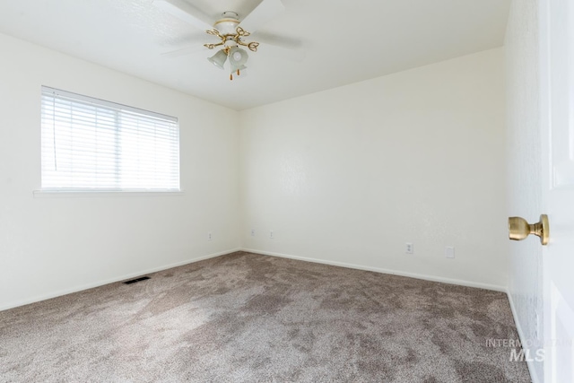 spare room featuring ceiling fan and carpet