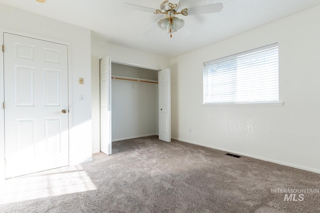 unfurnished bedroom featuring ceiling fan, a closet, and light carpet