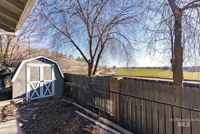 view of yard featuring a rural view and a shed