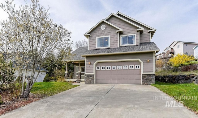 1962 E 6th St, Moscow, ID 83843 - craftsman house featuring a front lawn, stone siding, a garage, and concrete driveway