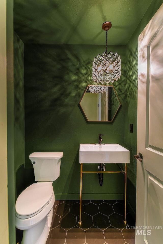 1962 E 6th St, Moscow, ID 83843 - bathroom featuring tile patterned floors, a sink, and toilet