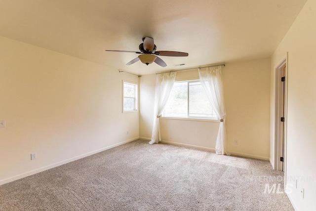 1962 E 6th St, Moscow, ID 83843 - empty room featuring baseboards, visible vents, light colored carpet, and a ceiling fan