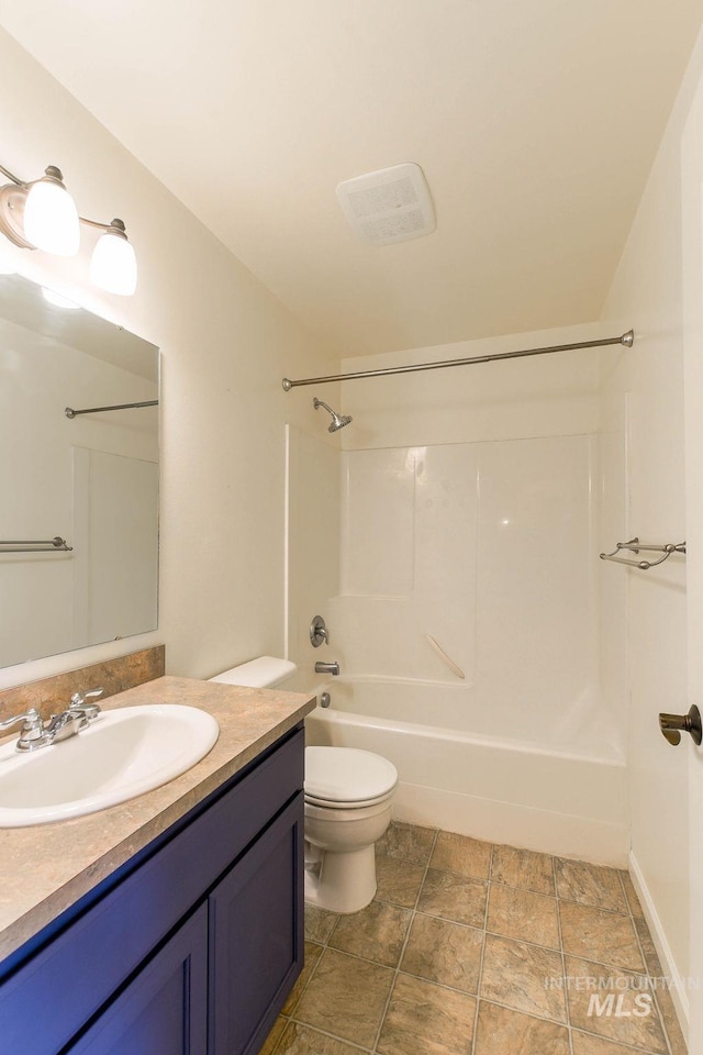 1962 E 6th St, Moscow, ID 83843 - bathroom featuring bathing tub / shower combination, stone finish floor, vanity, toilet, and baseboards