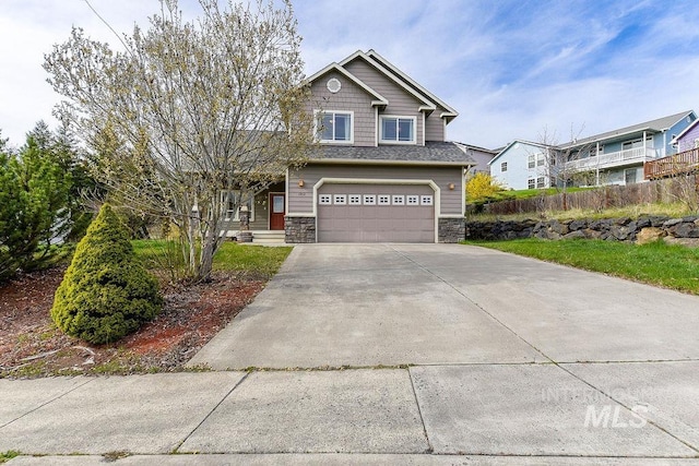 1962 E 6th St, Moscow, ID 83843 - craftsman inspired home featuring an attached garage, concrete driveway, fence, and stone siding