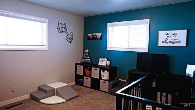 carpeted bedroom with a crib