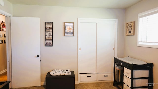 carpeted bedroom with a closet