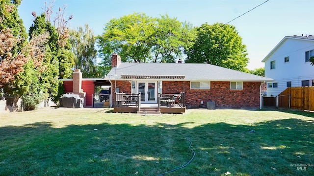 back of house featuring a yard, a wooden deck, and central AC unit