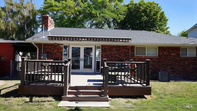 back of property featuring a wooden deck, a yard, and central air condition unit