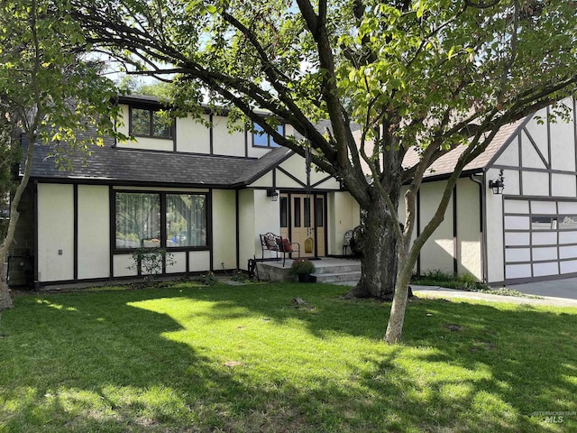 354 W Syringa Ct, Lewiston, ID 83501 - rear view of property with stucco siding, a garage, a shingled roof, and a lawn