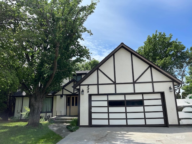 354 W Syringa Ct, Lewiston, ID 83501 - tudor house with stucco siding, an attached garage, and driveway
