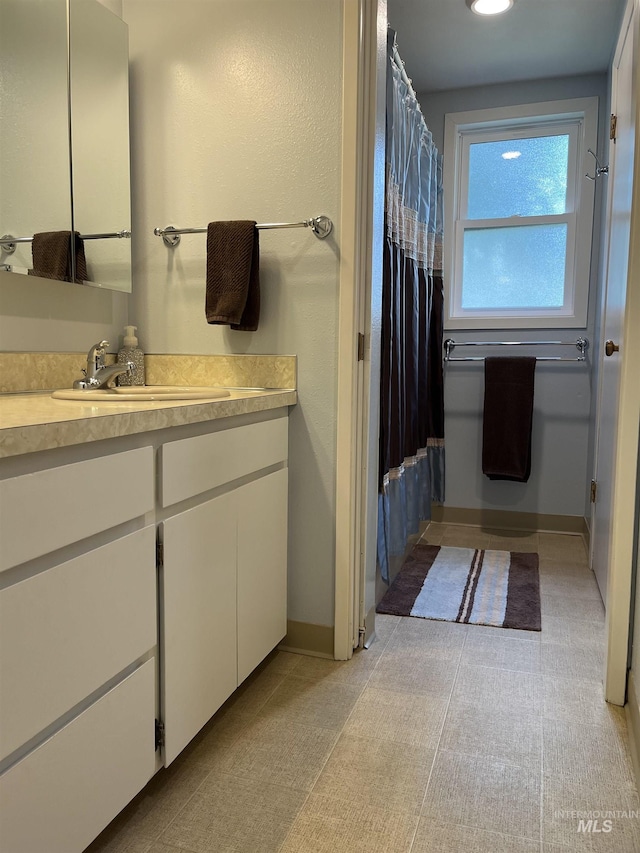 354 W Syringa Ct, Lewiston, ID 83501 - full bathroom featuring vanity, a shower with curtain, and baseboards