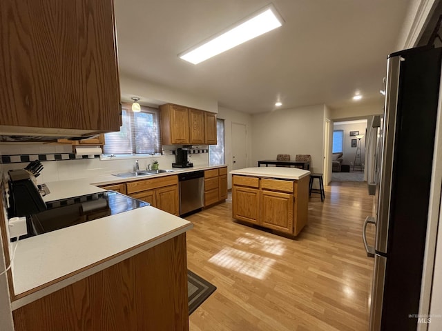 354 W Syringa Ct, Lewiston, ID 83501 - kitchen with appliances with stainless steel finishes, a sink, light wood-style flooring, brown cabinetry, and light countertops