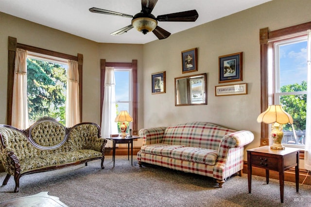 living area with ceiling fan and carpet
