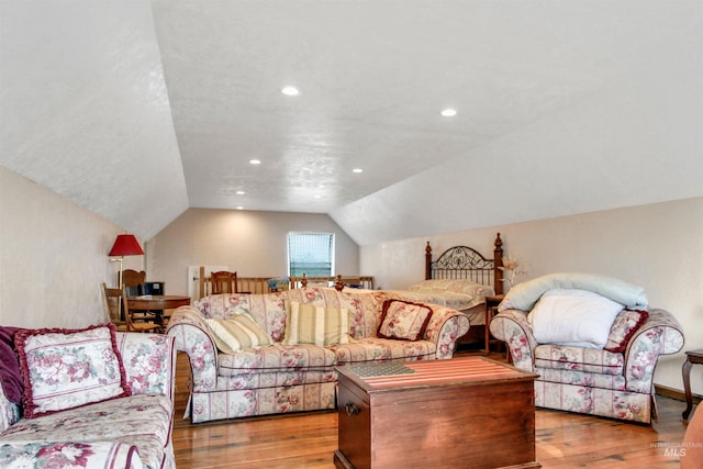living room featuring wood finished floors, vaulted ceiling, and recessed lighting