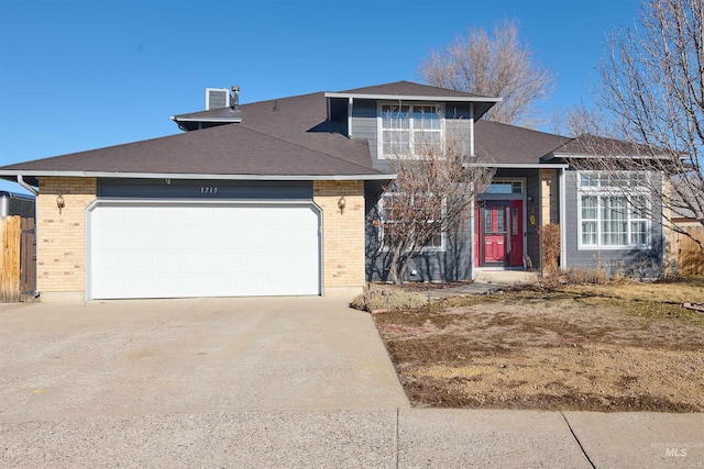 view of front of home featuring brick siding, concrete driveway, and a garage