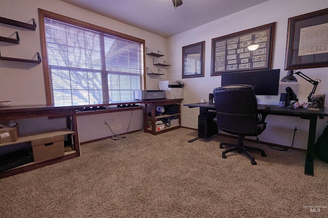 carpeted home office featuring baseboards