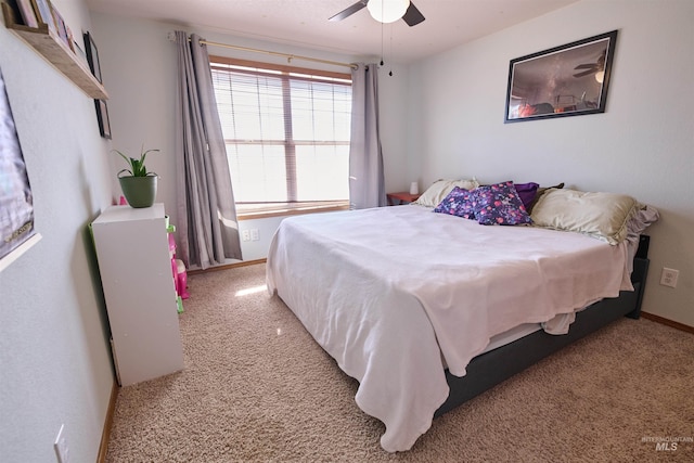 carpeted bedroom with baseboards and ceiling fan