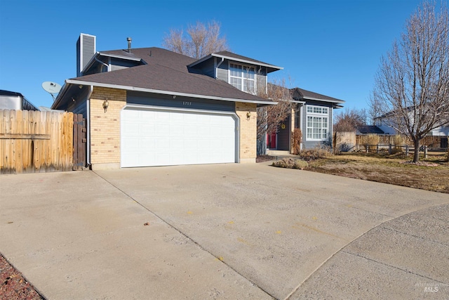 view of front of property with concrete driveway, a garage, fence, and brick siding