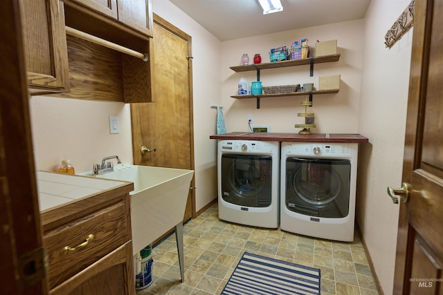 washroom featuring washer and dryer, baseboards, and stone finish flooring