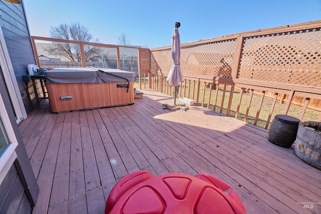 wooden deck with fence and a hot tub