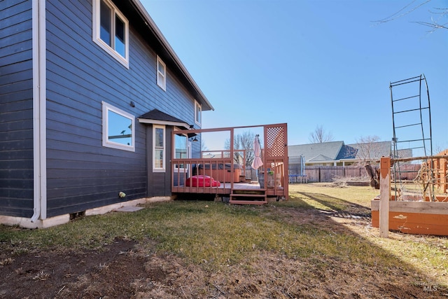 view of yard featuring a deck and fence