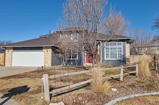 view of front facade featuring brick siding, an attached garage, concrete driveway, and fence