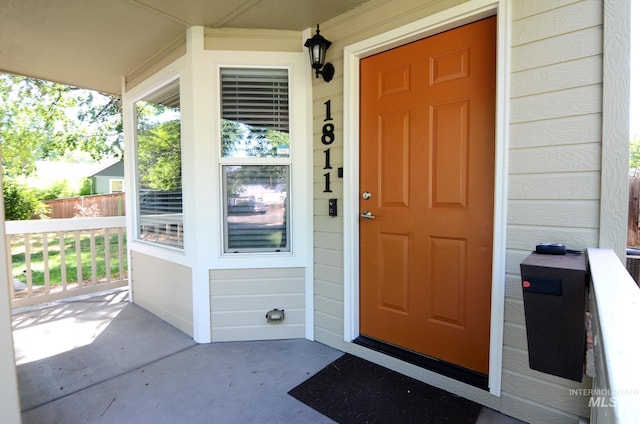 view of exterior entry with covered porch