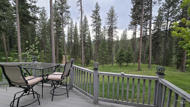 24 Shady Ln, Garden Valley, ID 83622 - deck featuring outdoor dining area, a wooded view, and a yard