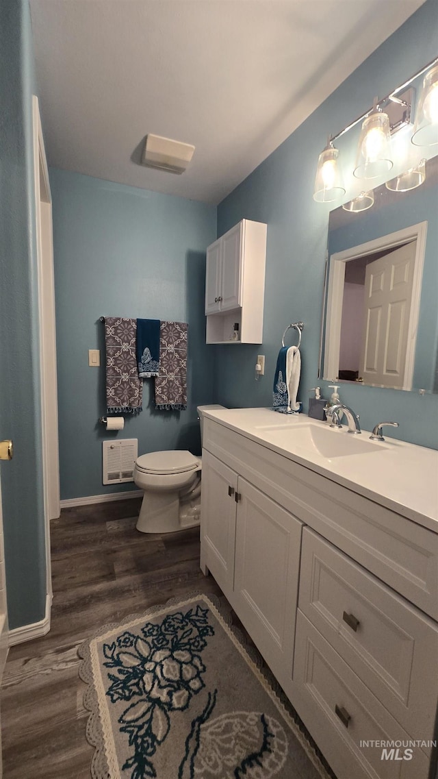 24 Shady Ln, Garden Valley, ID 83622 - bathroom with vanity, toilet, wood finished floors, and baseboards