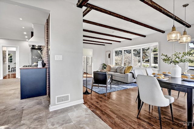 dining room featuring beam ceiling and hardwood / wood-style floors